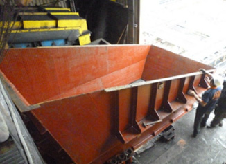 Fabricated transfer chute with primer coat
