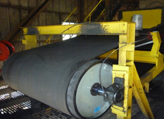 Rubber-lagged conveyor pulley on the lathe