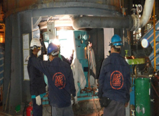 Major Engineering crew working at a burner on a plant floor