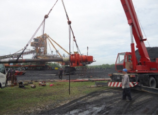 Crane lifting a stacker reclaimer structure on site