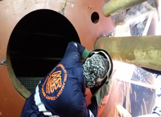 Technician working inside a mill pulverizer