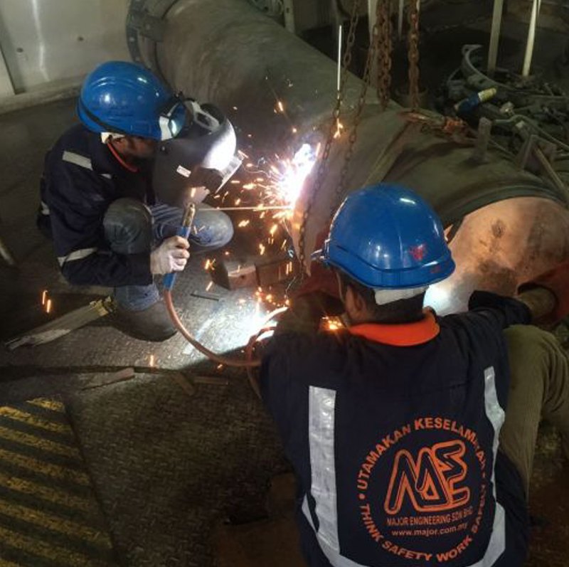 Two Major Engineering welders in company safety shirts working on site